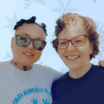 Two women against a snowflake backdrop