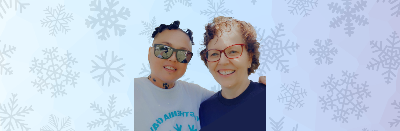 Two women against a snowflake backdrop