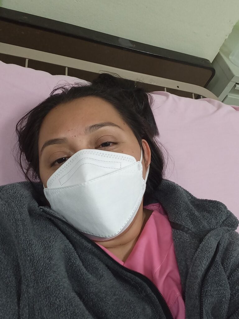 Gloria with a mask in hospital