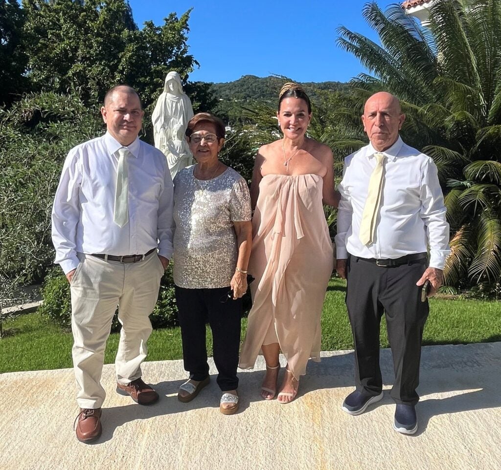 Family stands outside on a beautiful blue-sky day