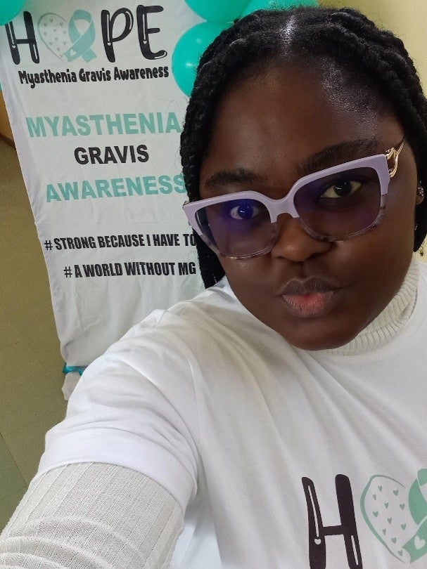 Sethunya in front of an MG Awareness banner