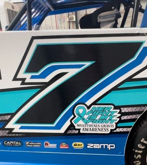 Number 7 car with MG awareness slogan